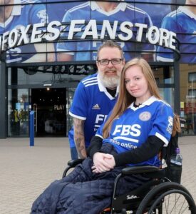 Michael and Alexa Penwell in front of Leicester Foxes Fanstore