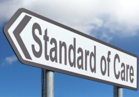 Directional sign with words "Standard of Care"